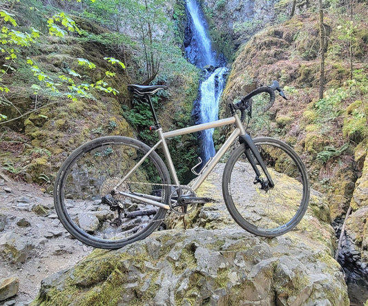 Titanium Gravel Frame on Rocks with Waterfall in Background